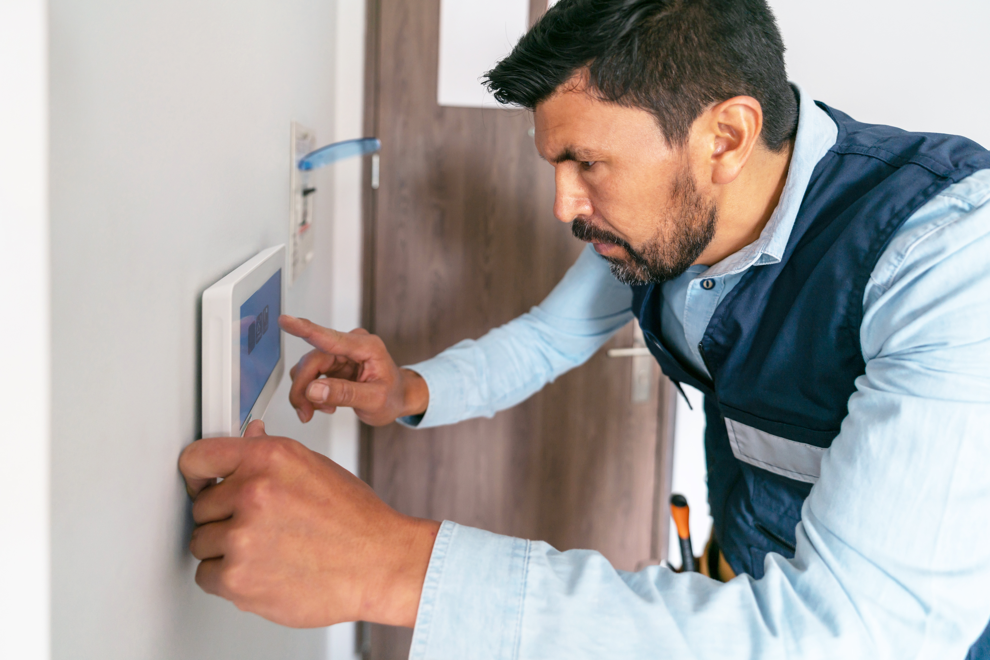 Technician installing security equipment